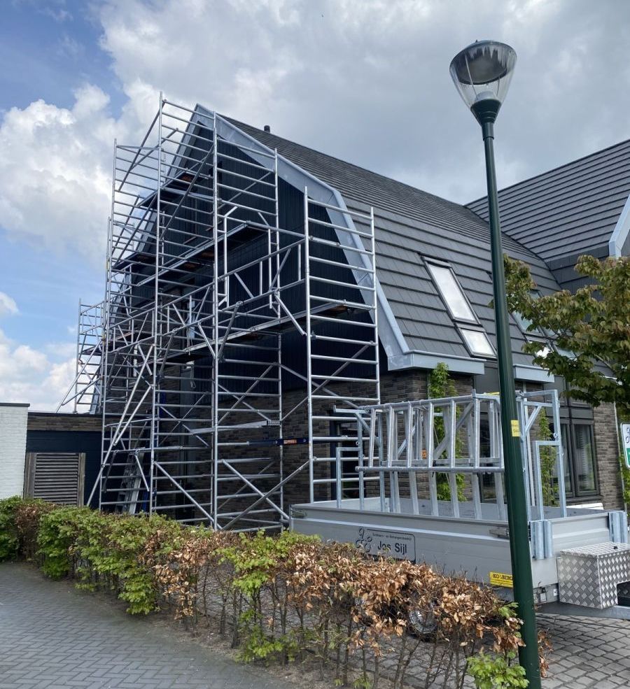 Een woning die tijdens de zomer in de steiger staat voor schilderwerk